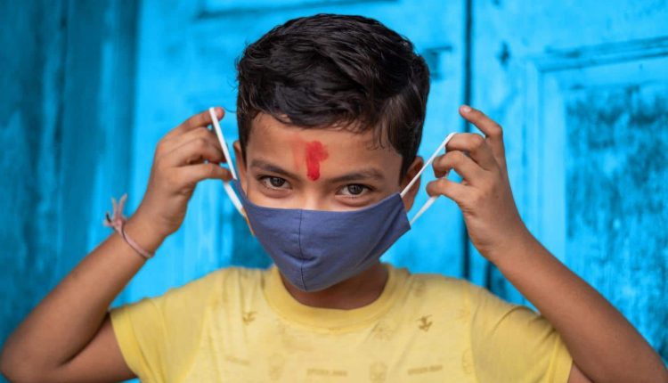 Un enfant portant son cache-nez anti-coronavirus